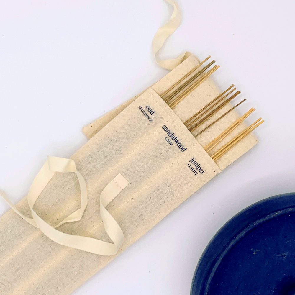 Set of wooden sticks in a beige carrying case on a white background